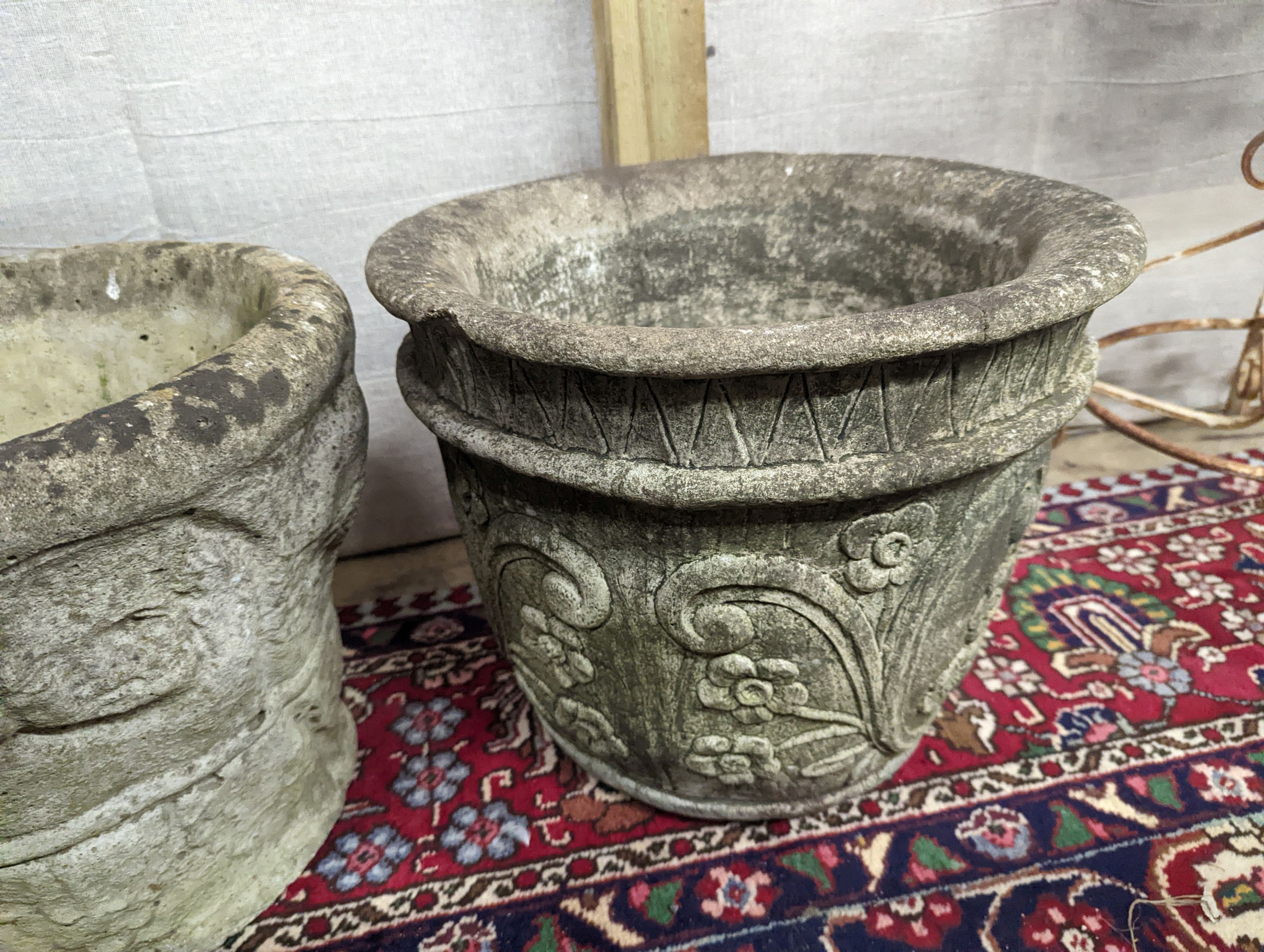 A reconstituted stone garden plinth, height 79cm, together with two circular garden planters, larger diameter 42cm